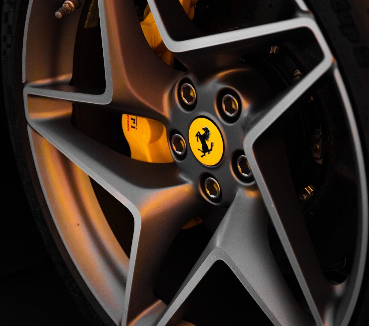 A close up of a Ferrari alloys with the logo.