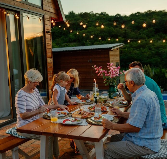 A family socialising in their holiday home garden.